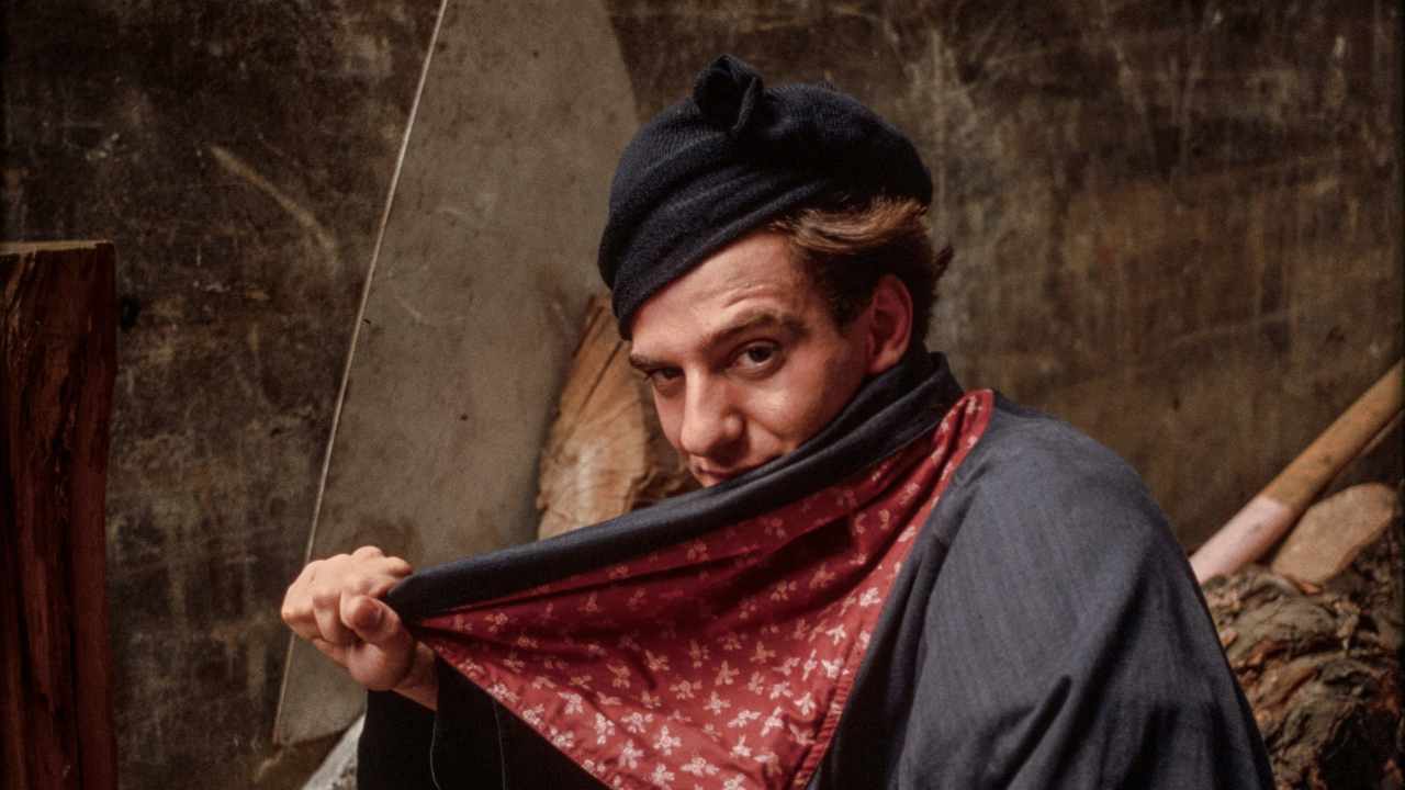 a man holding a scarf across his chin